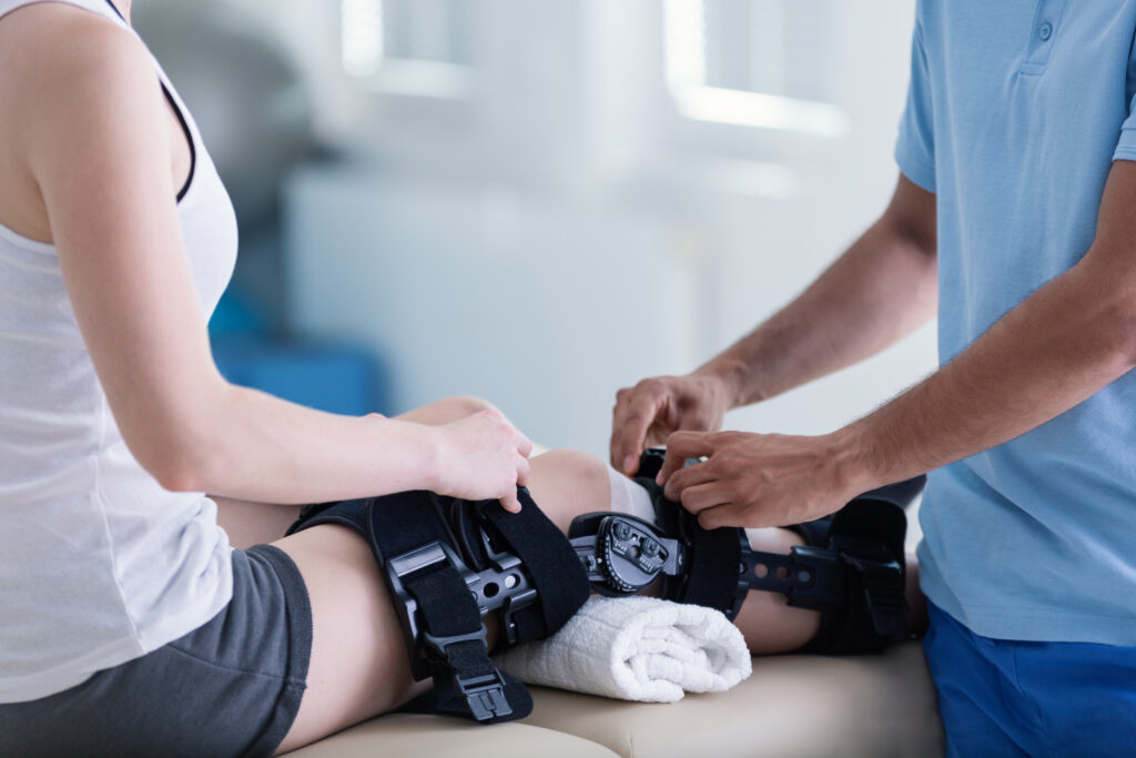 Close-up on person with stiffener on broken leg during rehabilit