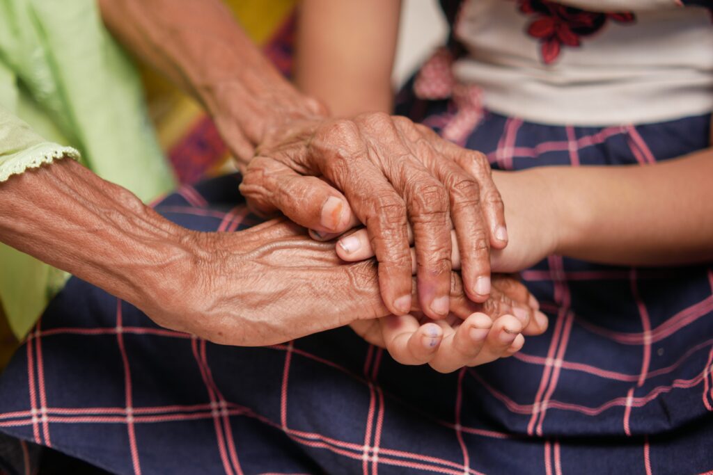 detail shot of child girl holding hand of a senior 2026 01 07 06 24 58 utc
